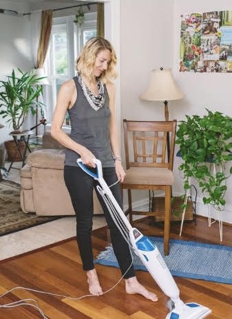 April cleaning a hardwood floor with a steam mop